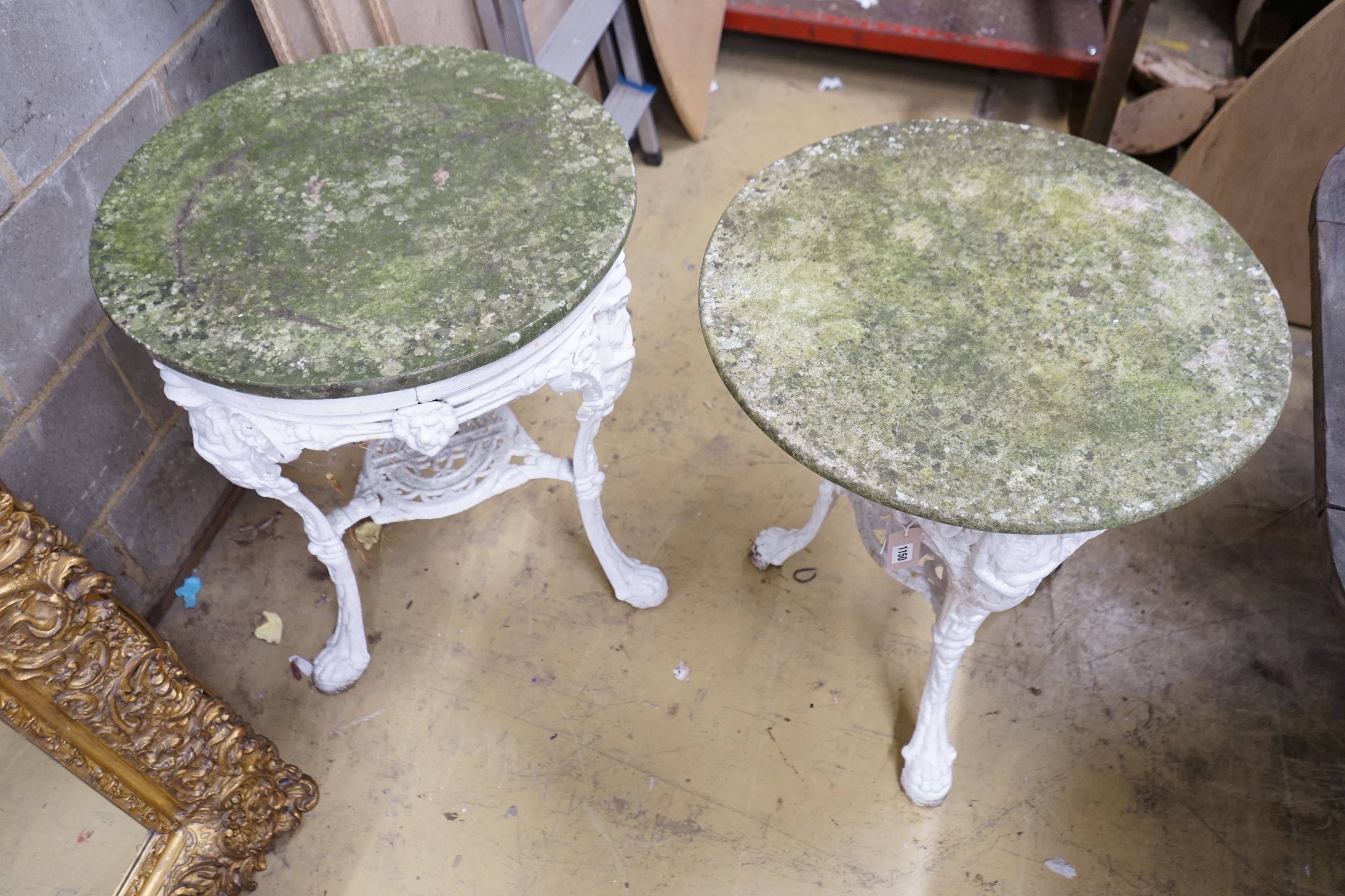 A pair of cast iron circular marble top tables, diameter 60cm, height 72cm